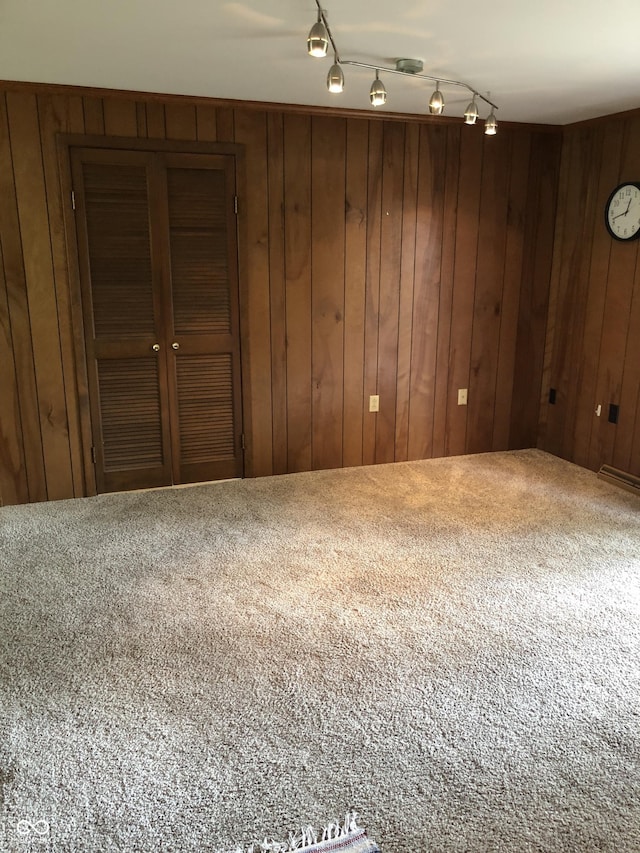 3619 31st St, Columbus, IN 47203 - carpeted spare room featuring wooden walls and rail lighting