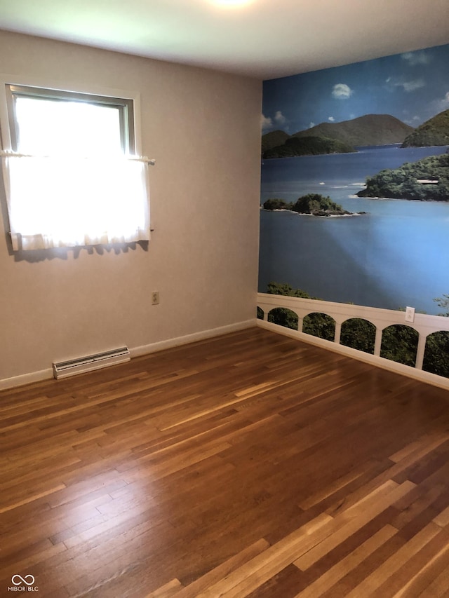 3619 31st St, Columbus, IN 47203 - spare room with wood finished floors, a baseboard radiator, and baseboards