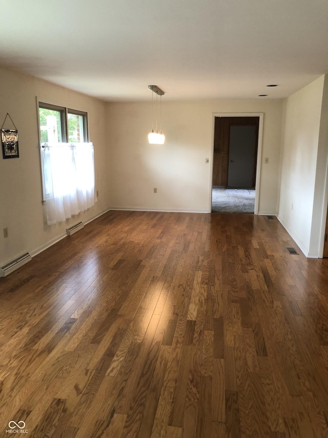 3619 31st St, Columbus, IN 47203 - spare room featuring dark wood-style flooring, baseboard heating, and baseboards