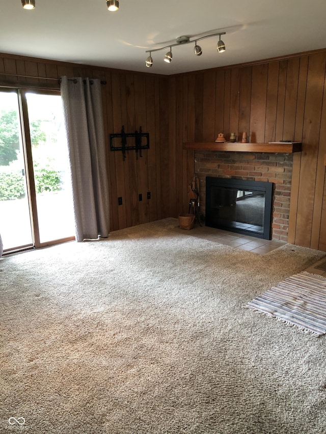 3619 31st St, Columbus, IN 47203 - unfurnished living room featuring a fireplace, carpet, and wood walls