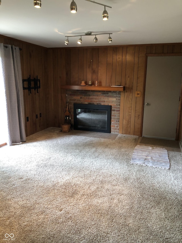 3619 31st St, Columbus, IN 47203 - unfurnished living room with a brick fireplace, carpet, and wood walls