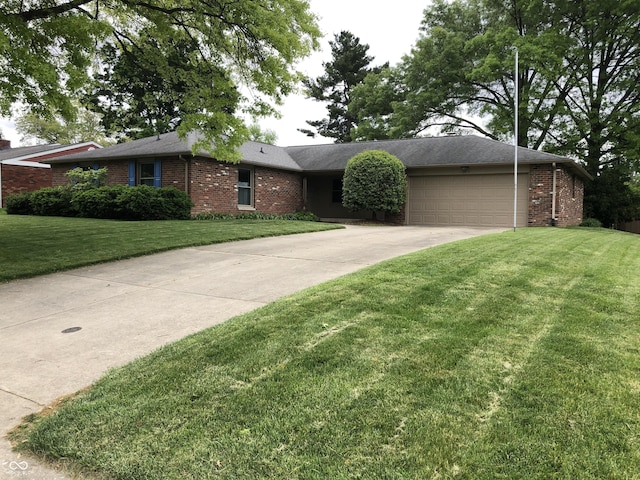3619 31st St, Columbus, IN 47203 - ranch-style home with brick siding, concrete driveway, a front lawn, and an attached garage
