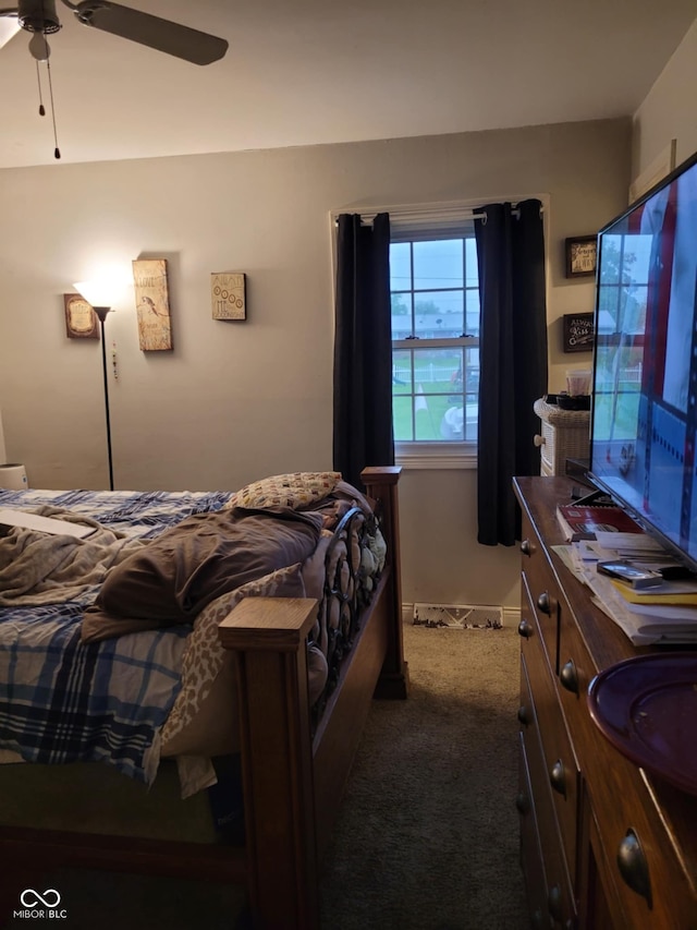 bedroom with dark colored carpet and ceiling fan