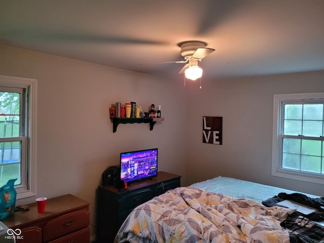 bedroom featuring multiple windows and ceiling fan