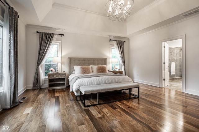 bedroom featuring a chandelier, crown molding, wood finished floors, baseboards, and ensuite bathroom