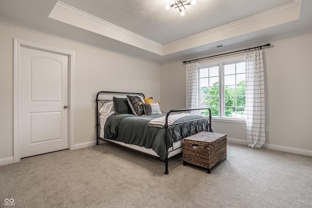 carpeted bedroom featuring a raised ceiling, crown molding, a textured ceiling, and baseboards