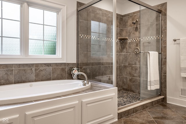 full bathroom with healthy amount of natural light and a stall shower
