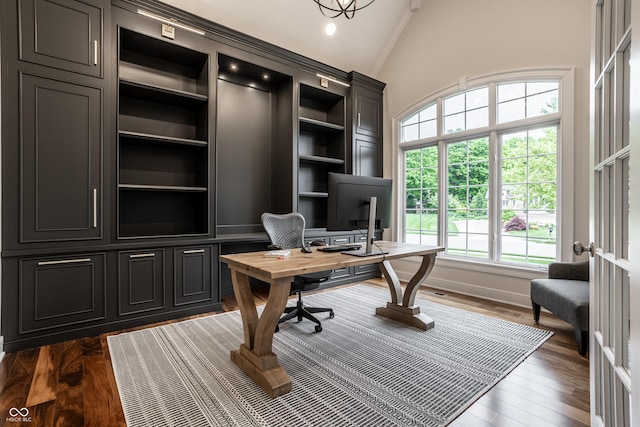 office area with dark wood-type flooring and lofted ceiling