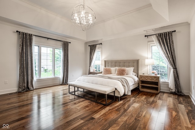 bedroom with a chandelier, ornamental molding, dark wood finished floors, and baseboards