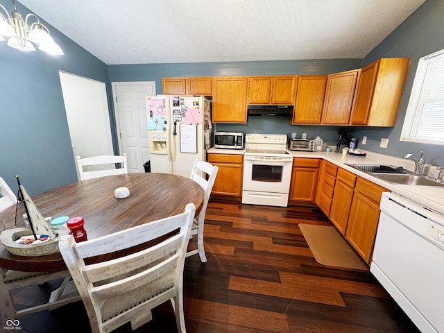 kitchen with white appliances, extractor fan, a sink, vaulted ceiling, and dark wood-type flooring
