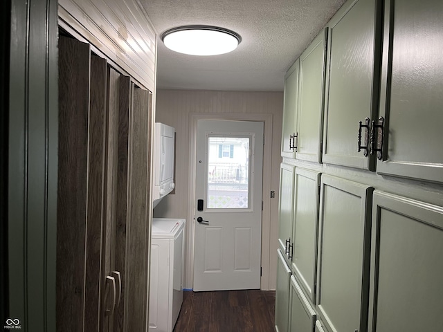 1216 N Cherry St, Rushville, IN 46173 - laundry room featuring cabinet space, dark wood finished floors, a textured ceiling, and stacked washer and clothes dryer