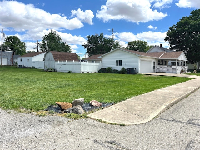 1216 N Cherry St, Rushville, IN 46173 - view of yard featuring an attached garage and driveway