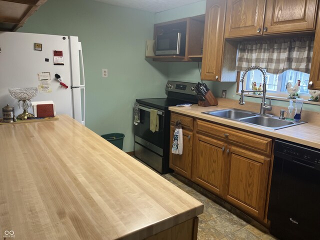 1216 N Cherry St, Rushville, IN 46173 - kitchen with stainless steel appliances, a sink, wood counters, and brown cabinets