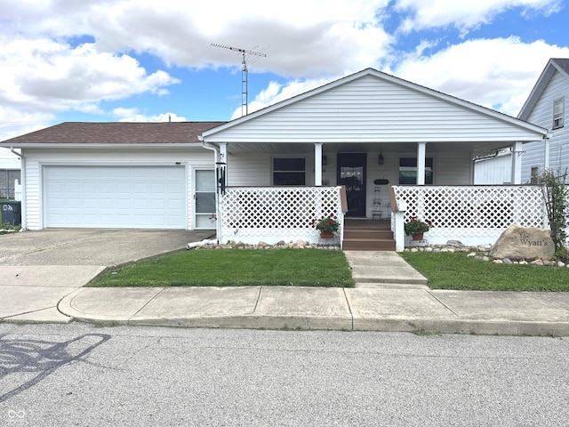 1216 N Cherry St, Rushville, IN 46173 - view of front of house featuring concrete driveway, a porch, an attached garage, roof with shingles, and a front lawn