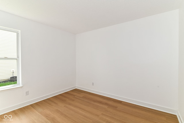 unfurnished room featuring light wood-type flooring and baseboards