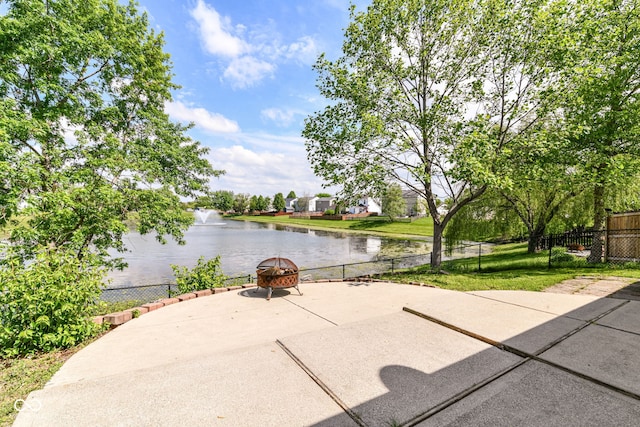view of patio featuring a water view and a fire pit