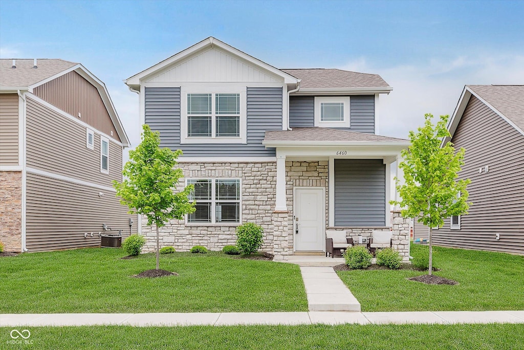 6460 Wasco Dr, Whitestown, IN 46075 - view of front of property featuring stone siding, a front lawn, and roof with shingles