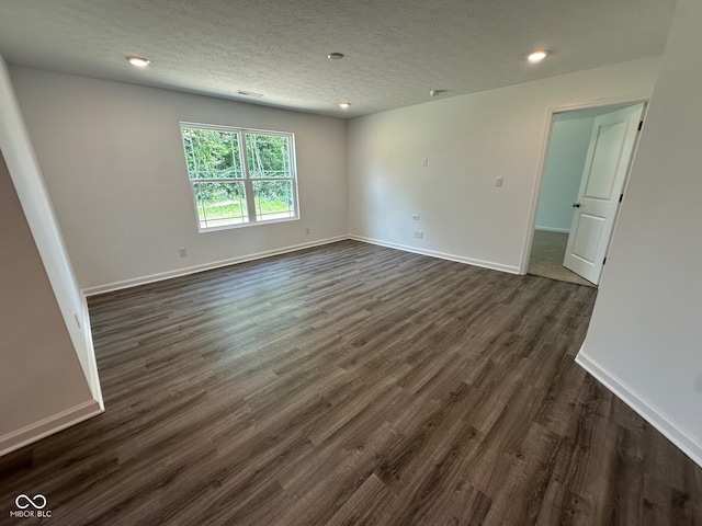 6712 Rawlings Ln, Indianapolis, IN 46221 - spare room featuring dark wood-style flooring, recessed lighting, and a textured ceiling
