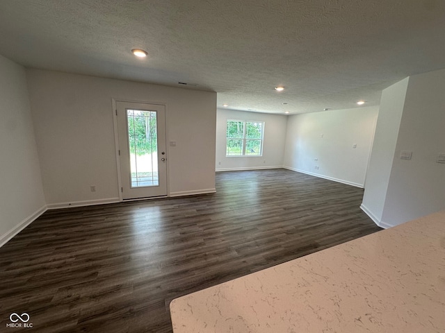 6712 Rawlings Ln, Indianapolis, IN 46221 - unfurnished room featuring dark wood-style flooring, a textured ceiling, and recessed lighting