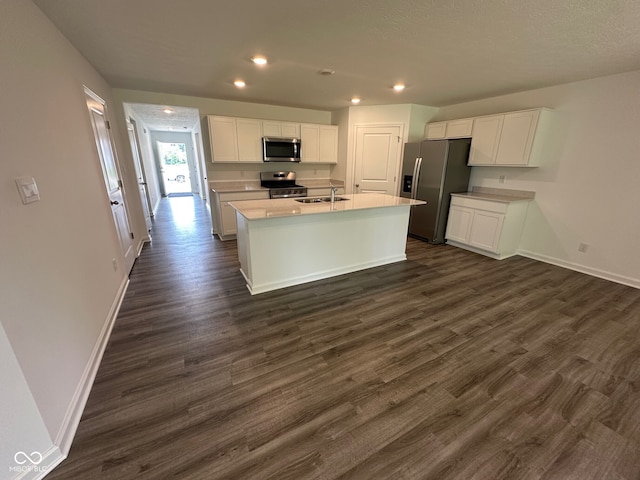 6712 Rawlings Ln, Indianapolis, IN 46221 - kitchen with stainless steel appliances, white cabinetry, dark wood-style flooring, recessed lighting, and an island with sink