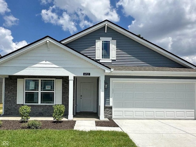 6712 Rawlings Ln, Indianapolis, IN 46221 - view of front of house featuring stone siding, concrete driveway, a porch, and an attached garage