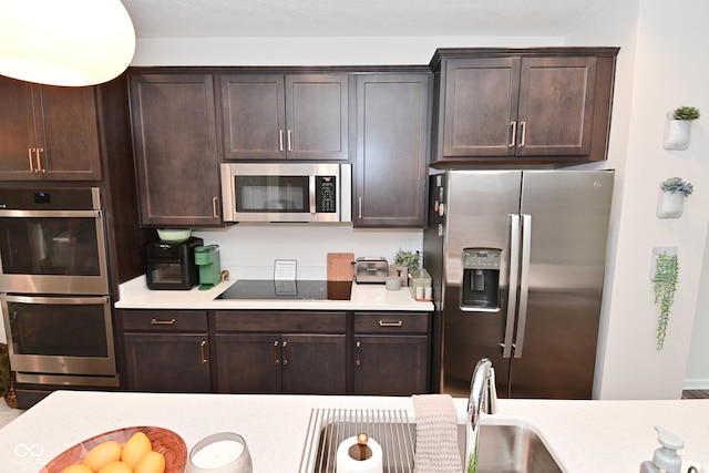 3110 W New York St, Indianapolis, IN 46222 - kitchen with stainless steel appliances, light countertops, and dark brown cabinets