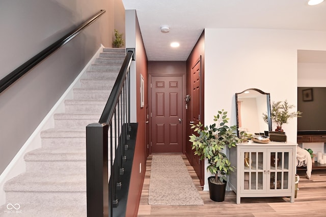 3110 W New York St, Indianapolis, IN 46222 - foyer featuring wood finished floors, stairway, and recessed lighting