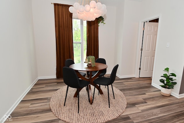 3110 W New York St, Indianapolis, IN 46222 - dining area with wood finished floors, baseboards, and a chandelier
