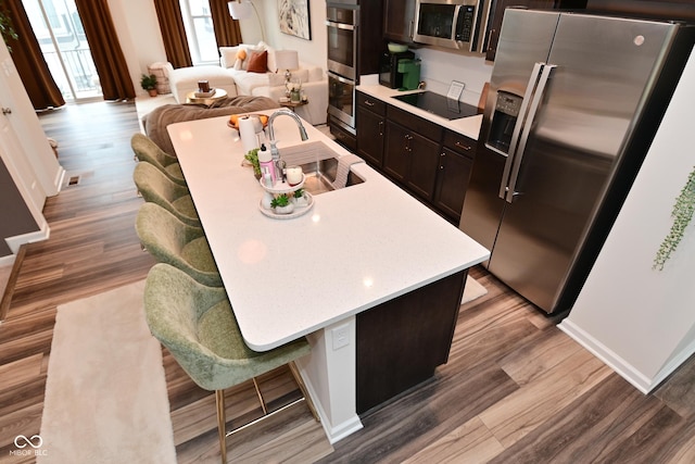 3110 W New York St, Indianapolis, IN 46222 - kitchen featuring appliances with stainless steel finishes, a sink, light countertops, and light wood-type flooring