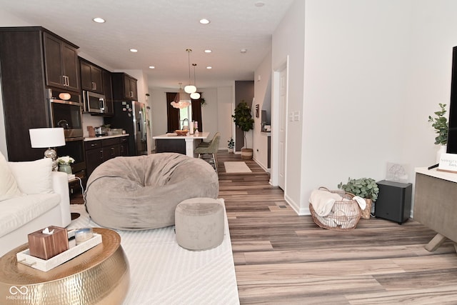 3110 W New York St, Indianapolis, IN 46222 - living area with light wood-type flooring, recessed lighting, and baseboards