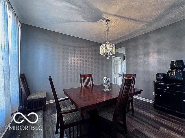 6155 W Bayfront, Mccordsville, IN 46055 - dining room featuring wood finished floors, a chandelier, baseboards, and a textured ceiling
