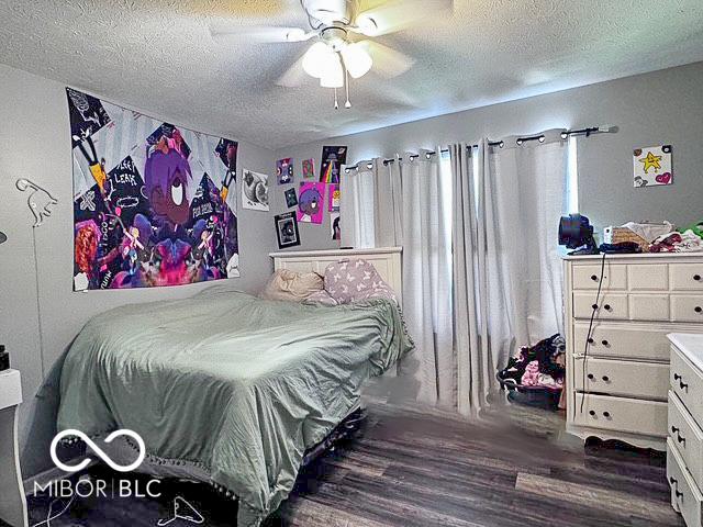 6155 W Bayfront, Mccordsville, IN 46055 - bedroom with a textured ceiling, wood finished floors, and ceiling fan