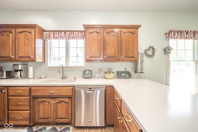 1105 Deer Creek Dr, Anderson, IN 46011 - kitchen featuring stainless steel dishwasher, a sink, brown cabinets, and light countertops