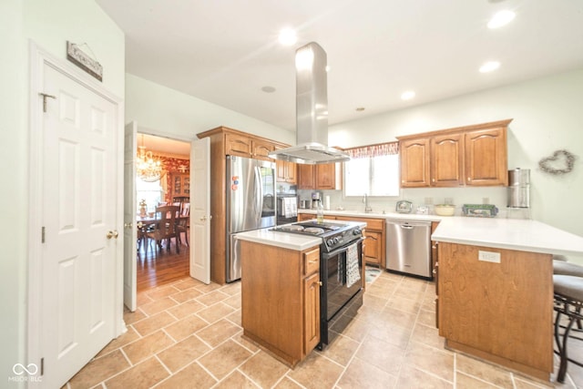 1105 Deer Creek Dr, Anderson, IN 46011 - kitchen featuring appliances with stainless steel finishes, a peninsula, a breakfast bar, a chandelier, and a kitchen island