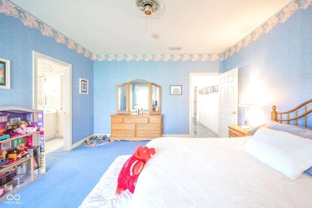 1105 Deer Creek Dr, Anderson, IN 46011 - carpeted bedroom featuring wallpapered walls, ensuite bathroom, and baseboards