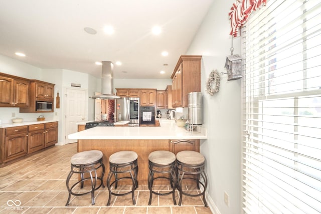 1105 Deer Creek Dr, Anderson, IN 46011 - kitchen with island exhaust hood, stainless steel appliances, a peninsula, a kitchen breakfast bar, and recessed lighting