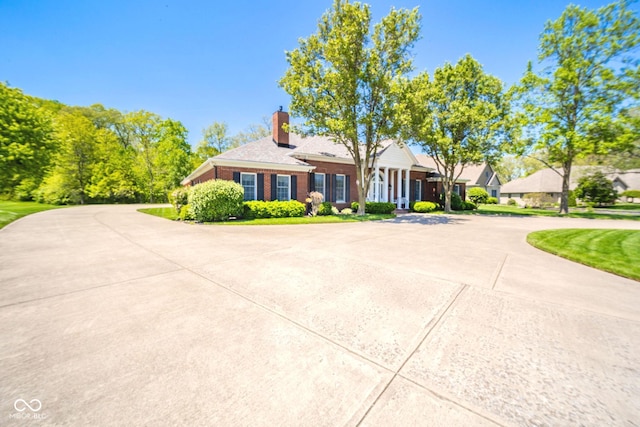 1105 Deer Creek Dr, Anderson, IN 46011 - view of front of property featuring brick siding, a chimney, and curved driveway
