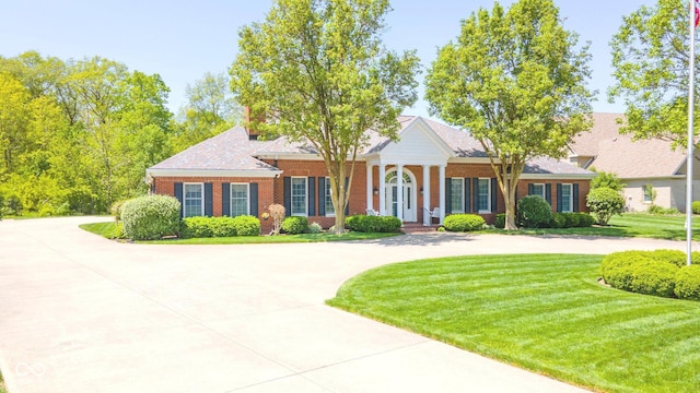 1105 Deer Creek Dr, Anderson, IN 46011 - greek revival inspired property featuring brick siding, a front lawn, and curved driveway