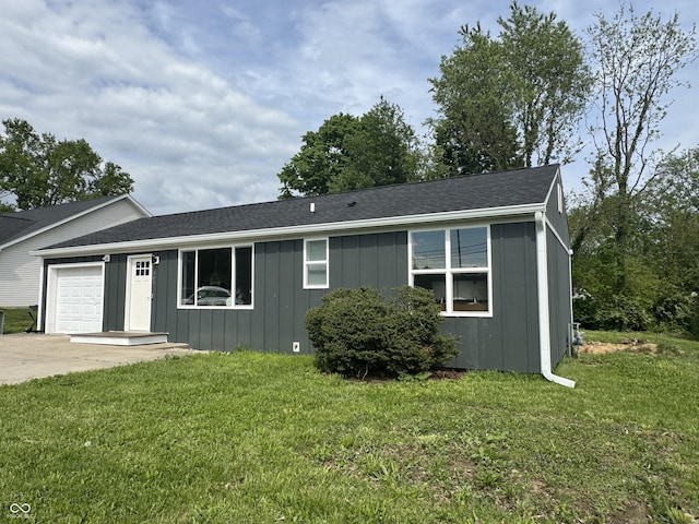 3641 S Rogers St, Bloomington, IN 47403 - single story home with board and batten siding, a garage, concrete driveway, and a front lawn
