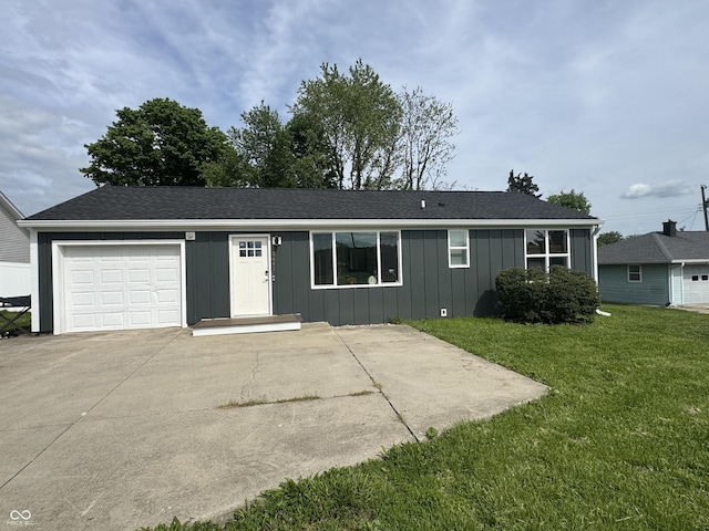 3641 S Rogers St, Bloomington, IN 47403 - single story home featuring a garage, board and batten siding, a front lawn, and concrete driveway