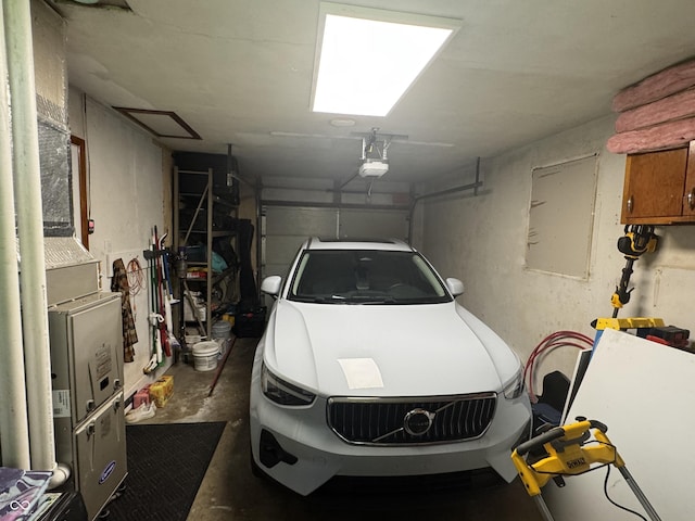 3641 S Rogers St, Bloomington, IN 47403 - garage featuring a garage door opener and electric panel