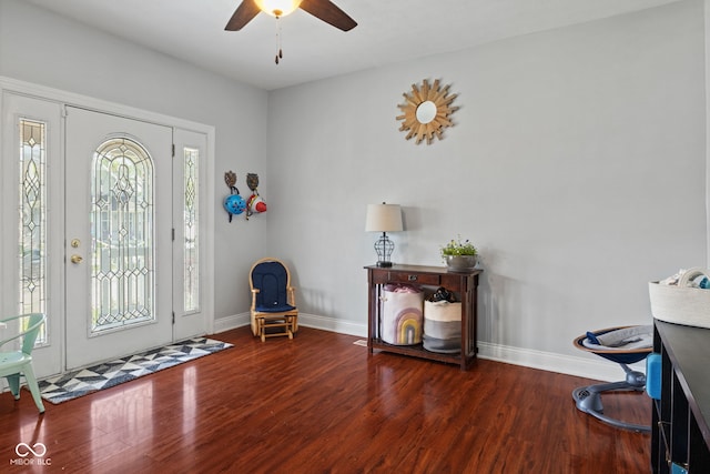 foyer entrance featuring wood finished floors, a ceiling fan, and baseboards