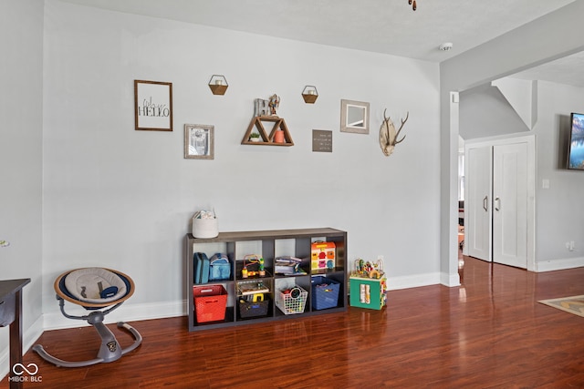 rec room with wood finished floors and baseboards