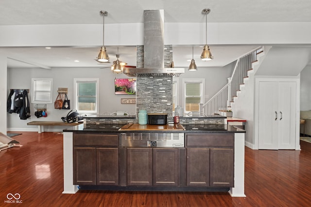 kitchen featuring dark wood-style flooring, island range hood, dark brown cabinets, and recessed lighting