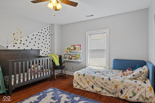bedroom with wood finished floors, baseboards, a ceiling fan, and lofted ceiling