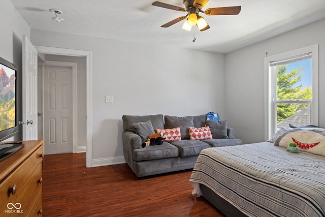 bedroom with dark wood finished floors, baseboards, and ceiling fan