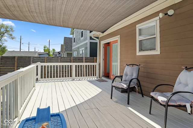 deck with a fenced backyard