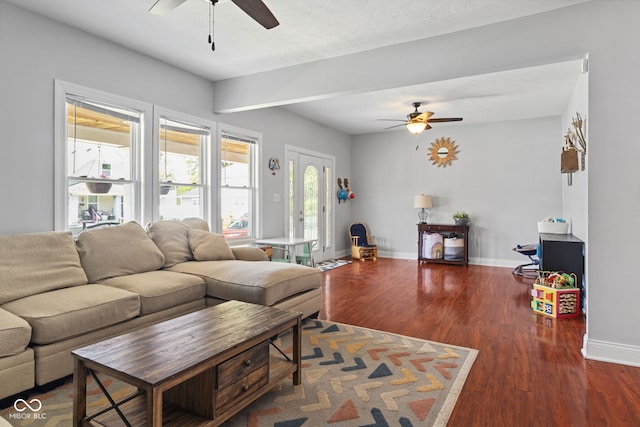 living area featuring ceiling fan, baseboards, and wood finished floors