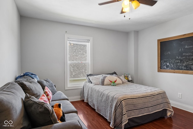 bedroom featuring baseboards, wood finished floors, and a ceiling fan