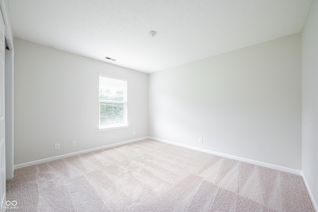 carpeted empty room with baseboards